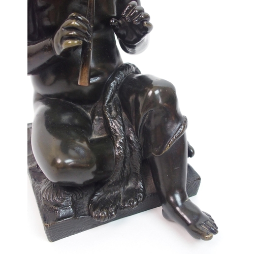 493 - A 20th Century bronze of a small boy playing a pipe