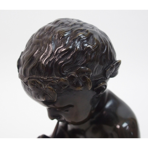 493 - A 20th Century bronze of a small boy playing a pipe