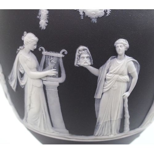 509 - A Wedgwood black jasper dip two-handled urn and cover