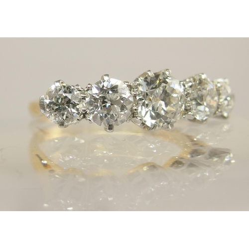 640 - An 18ct gold and platinum five stone diamond ring