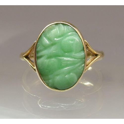 667 - A 9ct gold Chinese green hardstone ring