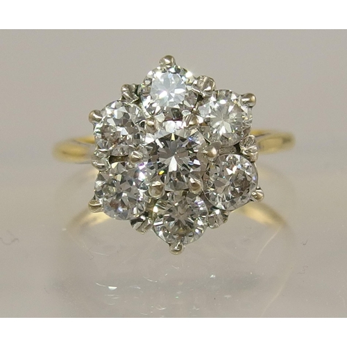 694 - An 18ct diamond flower ring