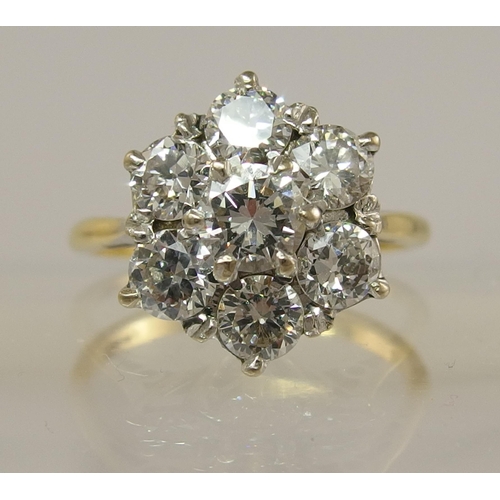 694 - An 18ct diamond flower ring