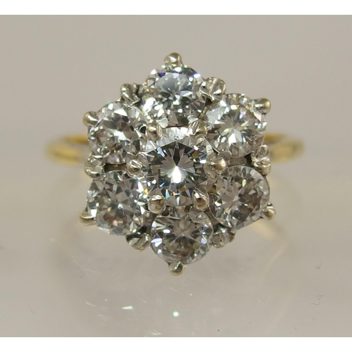 694 - An 18ct diamond flower ring