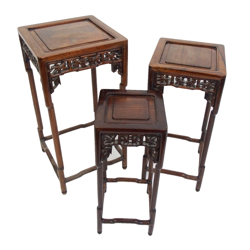 802 - A Chinese rosewood nest of three pedestal tables