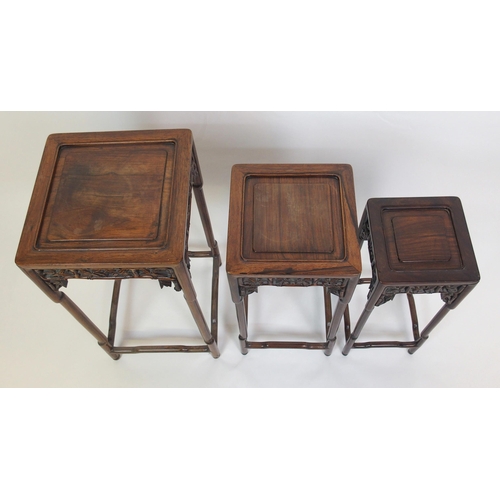 802 - A Chinese rosewood nest of three pedestal tables