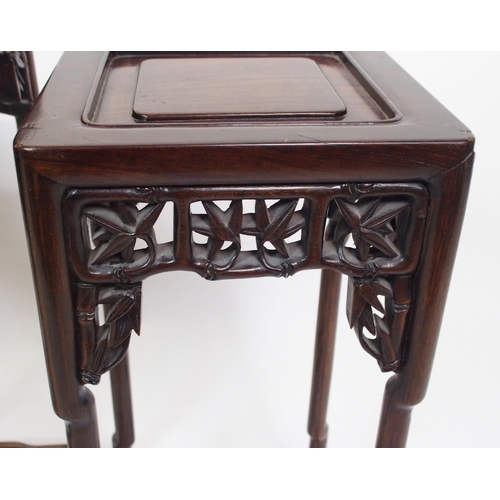 802 - A Chinese rosewood nest of three pedestal tables