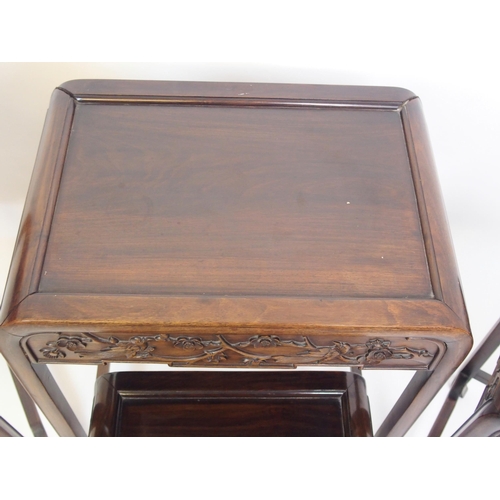 806 - A Chinese hardwood nest of four rectangular pedestal tables