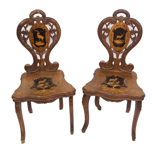 810 - A pair of Bavarian stained  inlaid and carved hall chairs