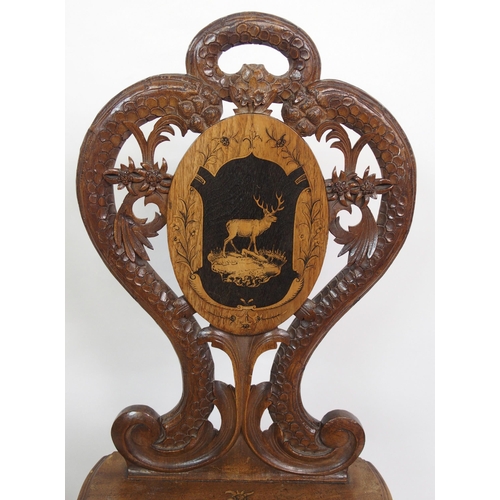 810 - A pair of Bavarian stained  inlaid and carved hall chairs