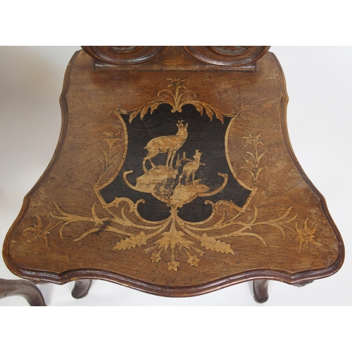 810 - A pair of Bavarian stained  inlaid and carved hall chairs