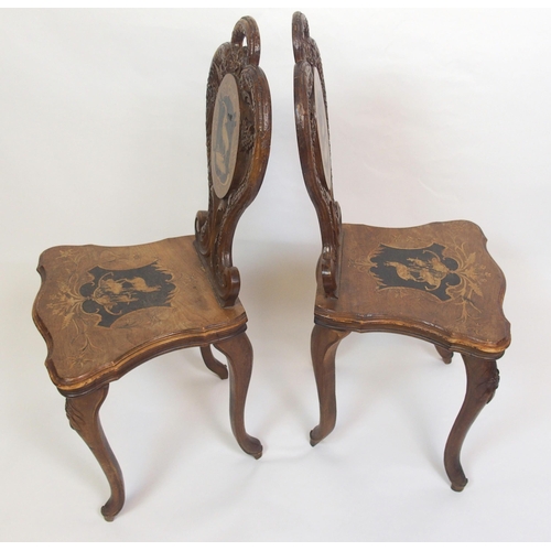 810 - A pair of Bavarian stained  inlaid and carved hall chairs