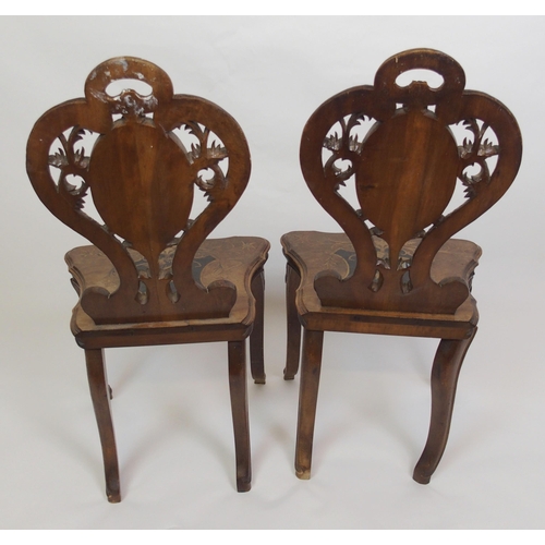 810 - A pair of Bavarian stained  inlaid and carved hall chairs