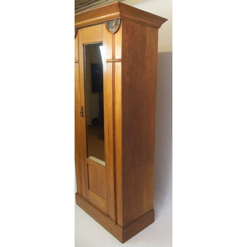 825 - An Arts and Crafts oak wardrobe