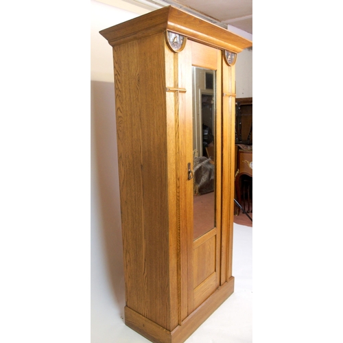 825 - An Arts and Crafts oak wardrobe