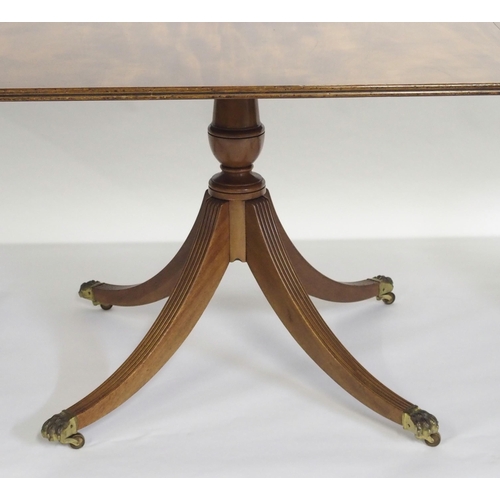 838 - A mahogany triple pillar D-end dining table