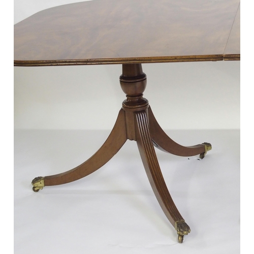 838 - A mahogany triple pillar D-end dining table