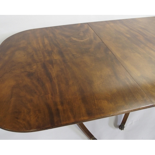 838 - A mahogany triple pillar D-end dining table