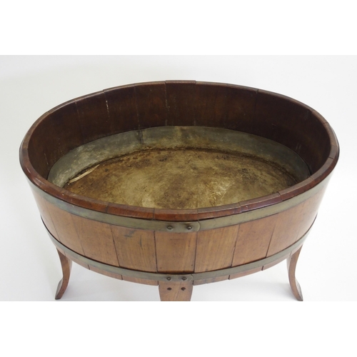 847 - An oak staved and brass bound oval planter