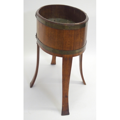 847 - An oak staved and brass bound oval planter