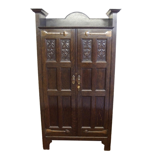 860 - A Scottish Arts and Crafts stained oak hall cupboard by Shapland and Petter  Barnstaple