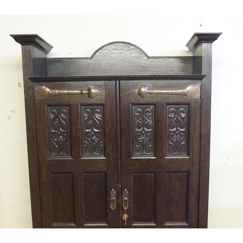 860 - A Scottish Arts and Crafts stained oak hall cupboard by Shapland and Petter  Barnstaple