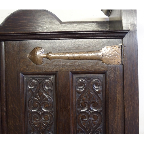 860 - A Scottish Arts and Crafts stained oak hall cupboard by Shapland and Petter  Barnstaple