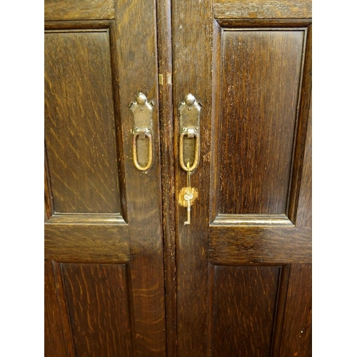 860 - A Scottish Arts and Crafts stained oak hall cupboard by Shapland and Petter  Barnstaple