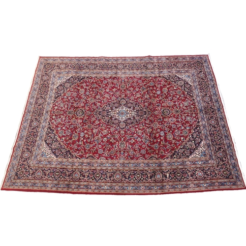 863 - A large red ground Persian Kashan rug