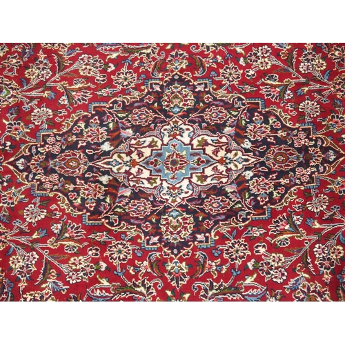 863 - A large red ground Persian Kashan rug