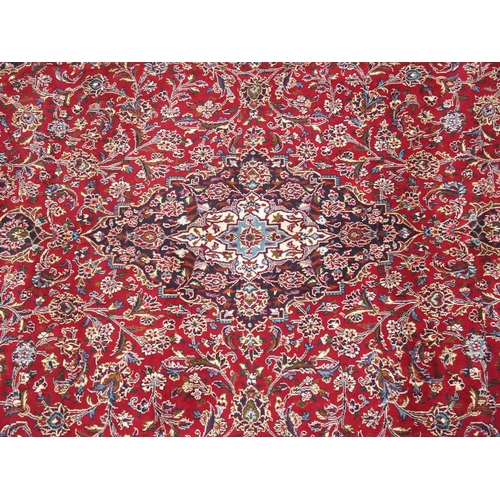 863 - A large red ground Persian Kashan rug