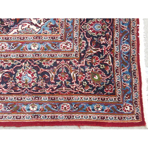 863 - A large red ground Persian Kashan rug