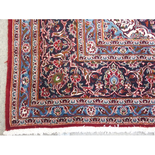 863 - A large red ground Persian Kashan rug