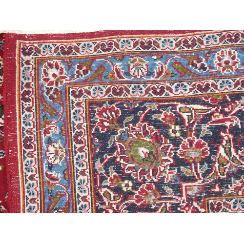 863 - A large red ground Persian Kashan rug