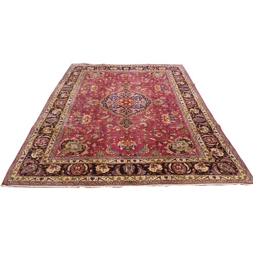 867 - A red ground Meshed rug