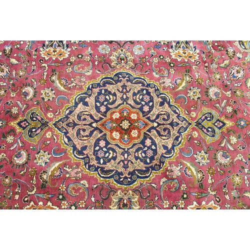 867 - A red ground Meshed rug