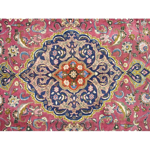 867 - A red ground Meshed rug