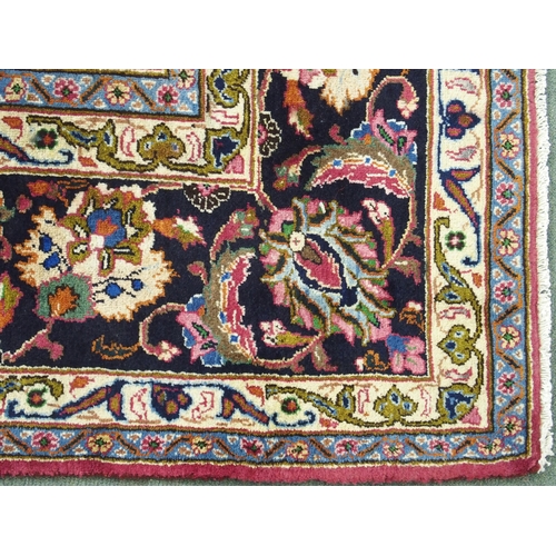 867 - A red ground Meshed rug