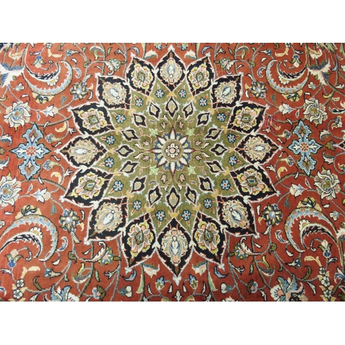 869 - A red ground Sarough rug