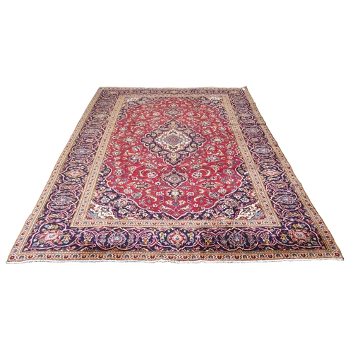 872 - A red ground Kashan rug