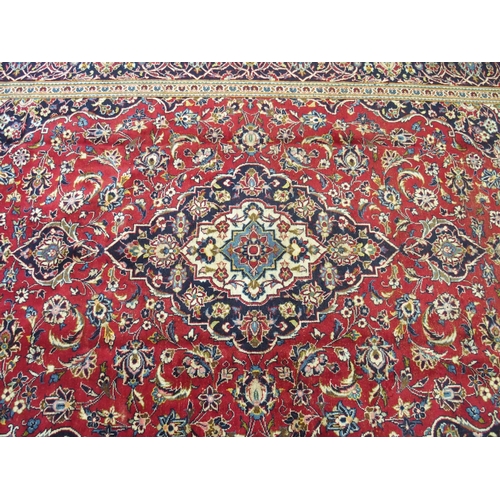 872 - A red ground Kashan rug