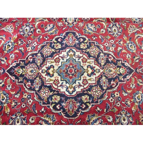 872 - A red ground Kashan rug