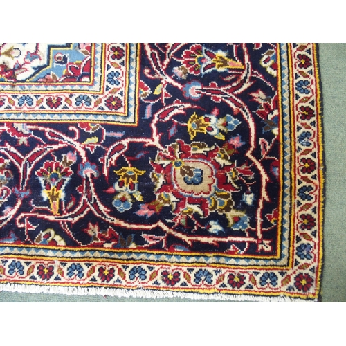 872 - A red ground Kashan rug