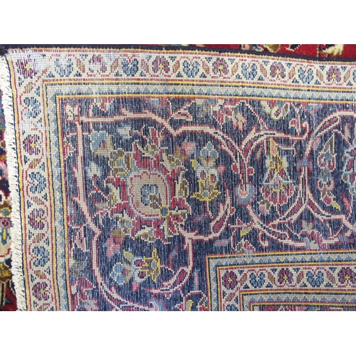 872 - A red ground Kashan rug