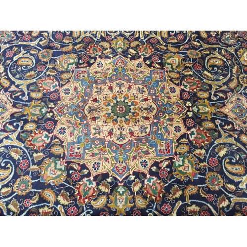 873 - A blue ground Meshed rug