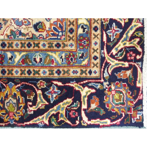 873 - A blue ground Meshed rug