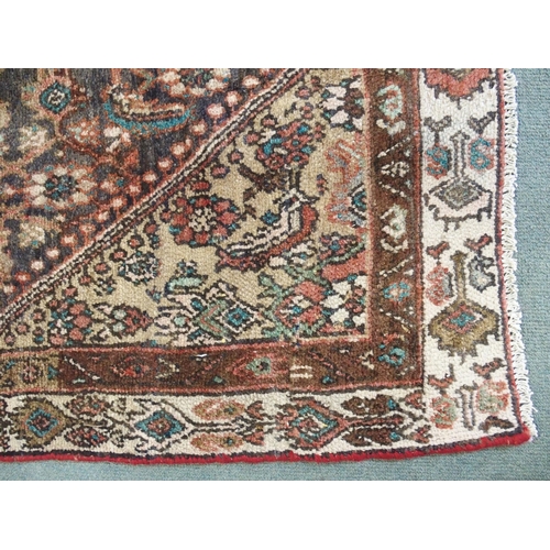 876 - A brown ground Hamadan runner