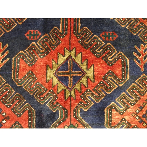 877 - A red and blue ground Malayer runner