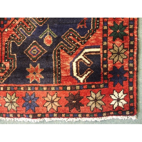 877 - A red and blue ground Malayer runner