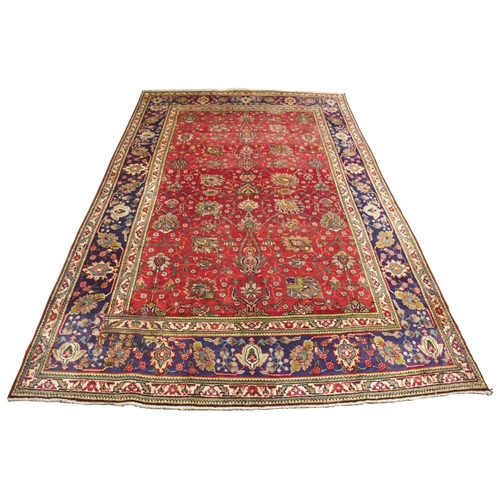 878 - A red ground Tabriz rug